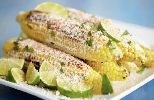Food close-up, with Cook and Corn on the cob