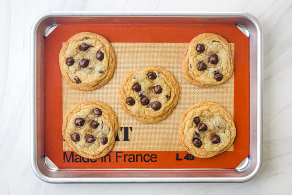 5 chocolate chip cookies on a quarter pan lined with silpat.