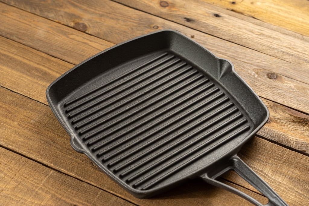 clean cast iron baking pan with grid on the table