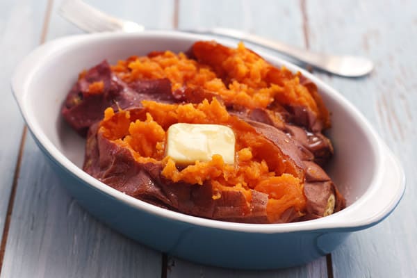 Butter baked sweet potatoes in a baking dish