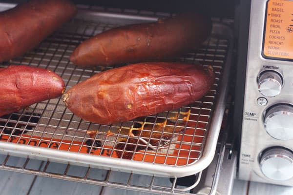 Sweet potatoes on a baking rack in a convection toaster oven