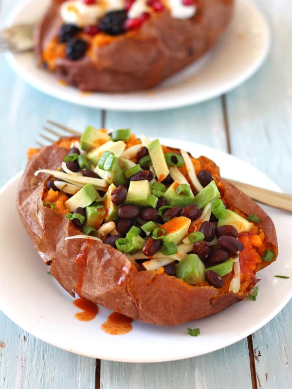 Baked sweet potato with black beans, butter and sauce