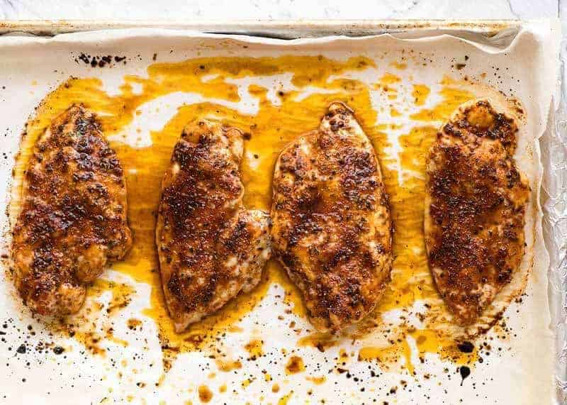 Aerial photo of Juicy Grilled Chicken Breasts on a tray, fresh out of the oven
