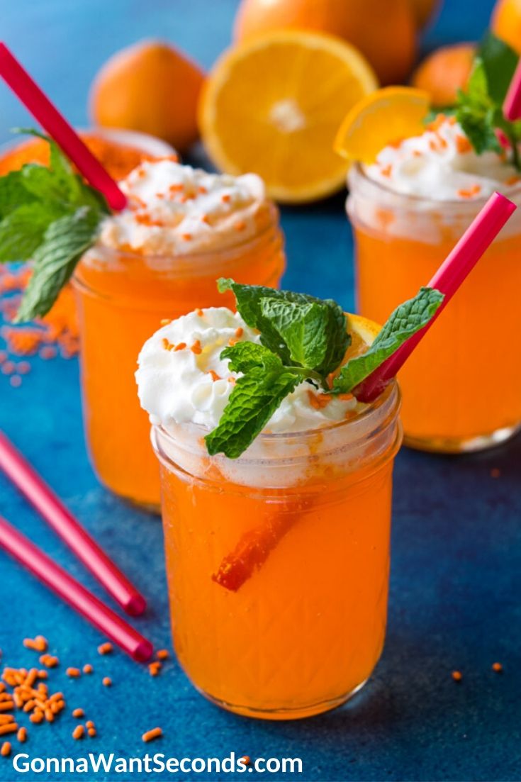 Orange cream drink topped with whipped cream and sprinkles