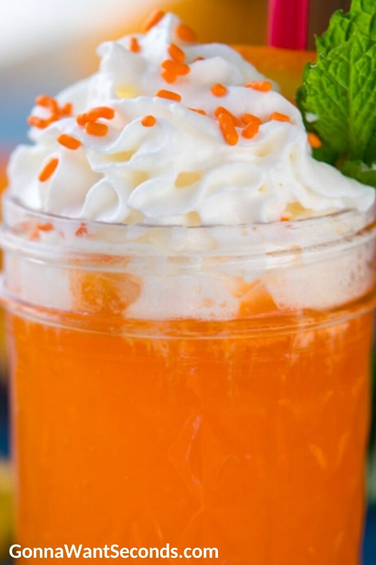 Orange cream drink topped with whipped cream and sprinkles