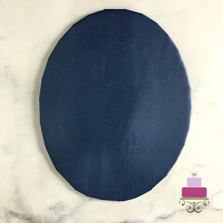 A DIY brown cake board wrapped in blue paper