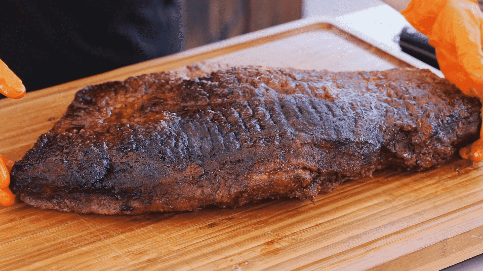 Smoked beef brisket is hot and quick on a wooden cutting board.
