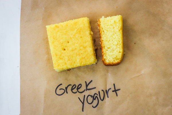 Pieces of lemon cake on brown parchment paper.