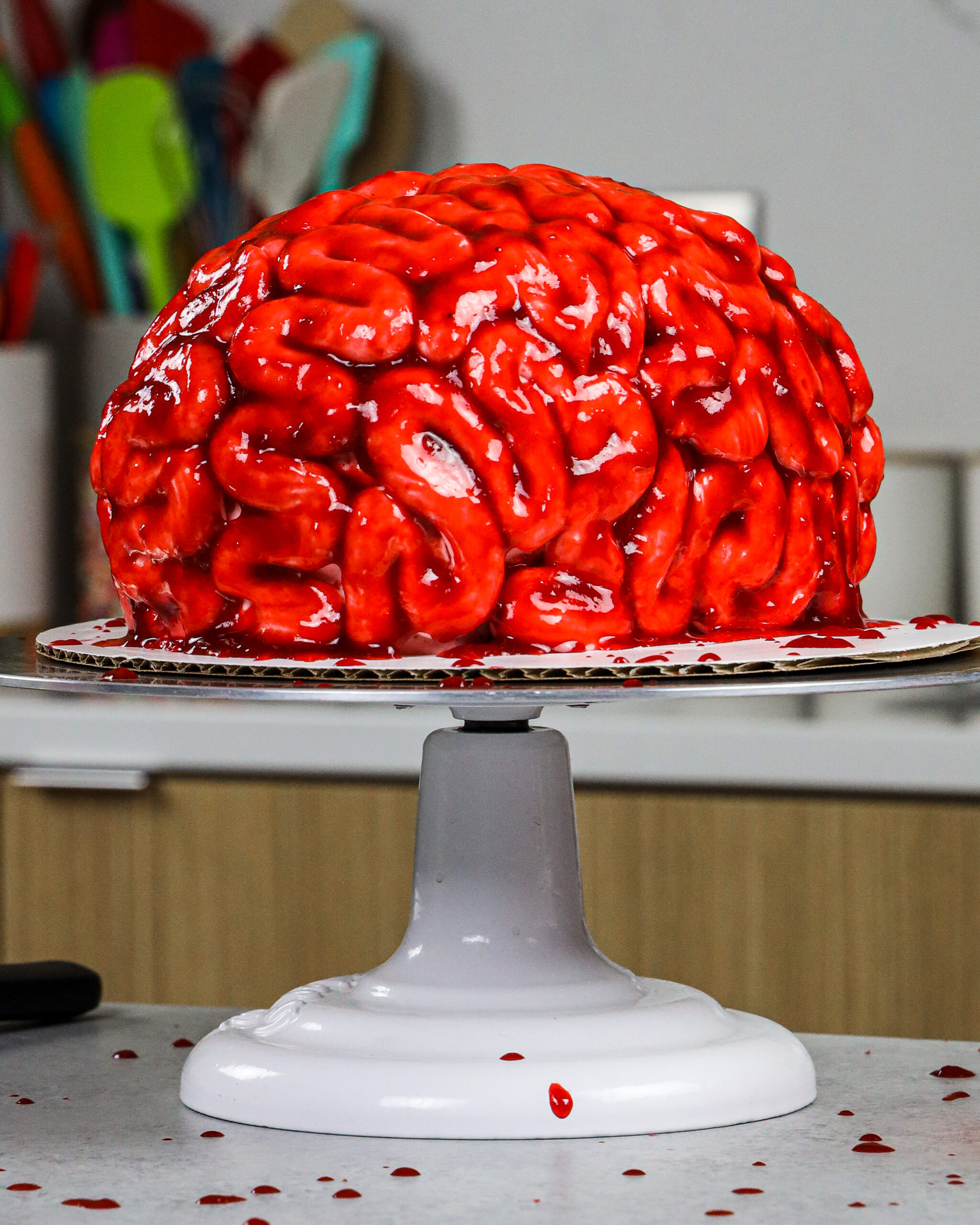 image of red velvet cake batter being poured into an 8-inch cake pan