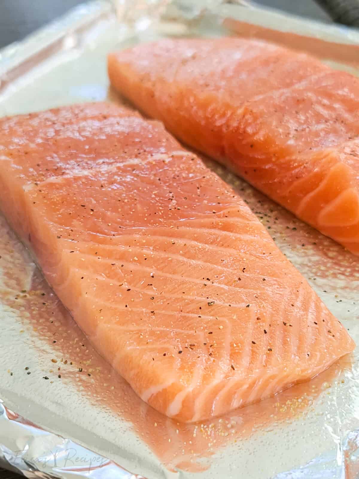 raw salmon on a baking pan