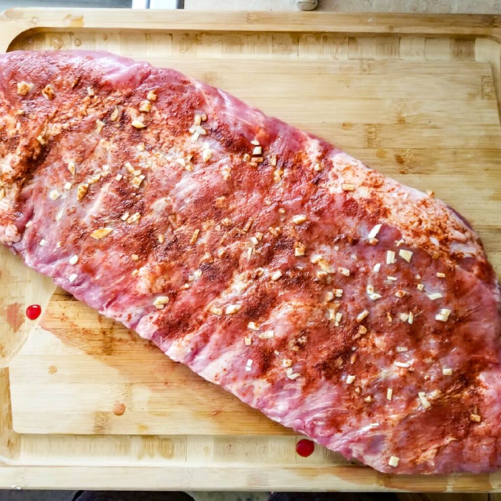 Arrange the ribs on a cutting board with seasoning ready to bake