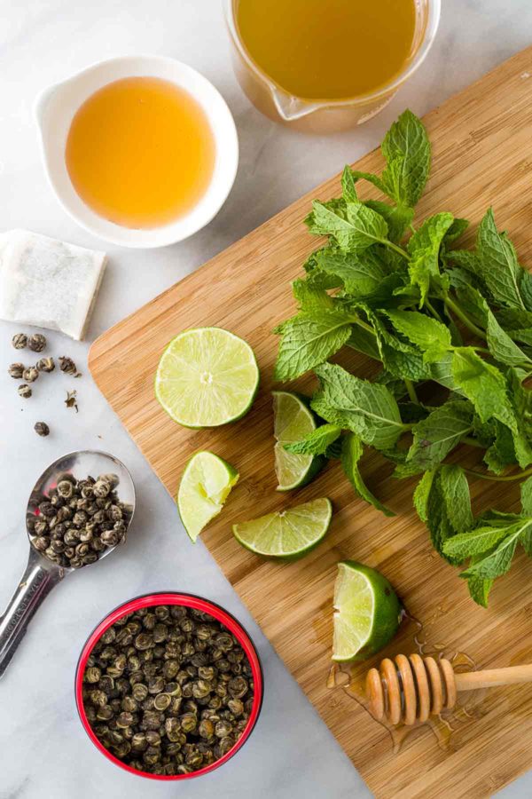 Top view of green tea ingredients on table and cutting board