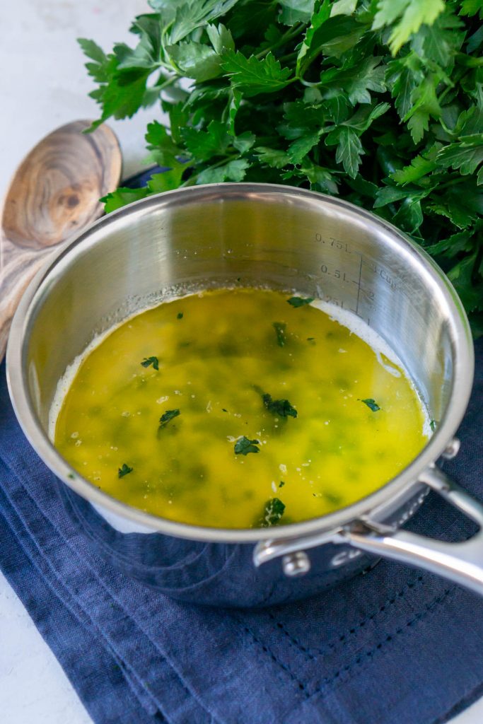 garlic butter sauce on pan with parsley