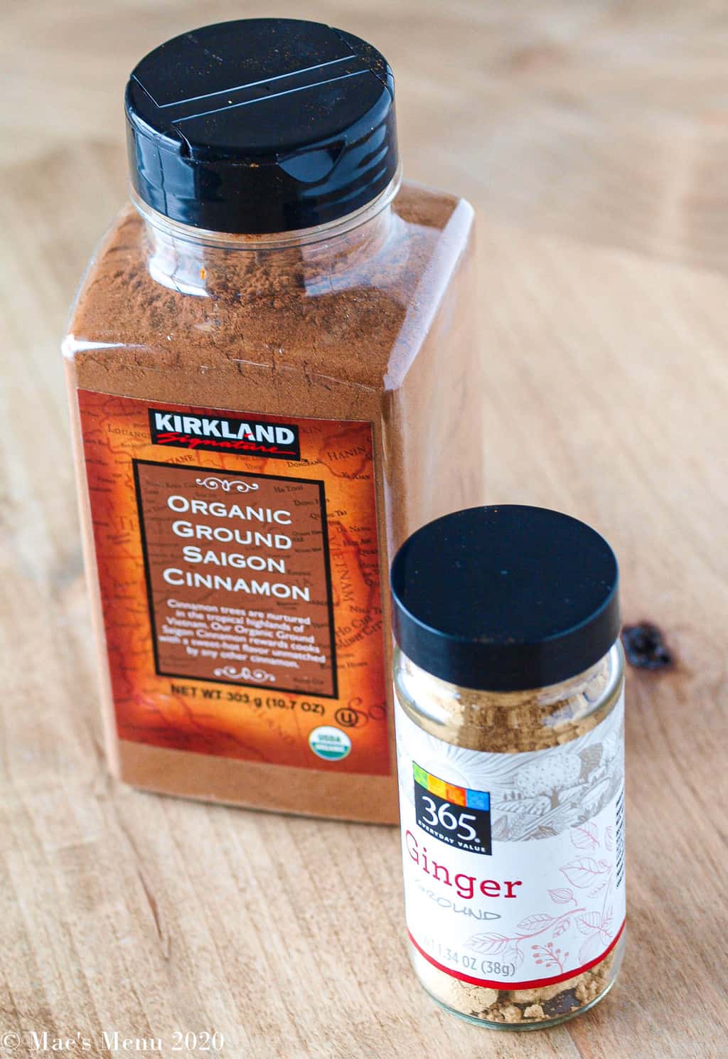 A large bottle of kirkland's saigon cinnamon next to a small bottle of ginger powder