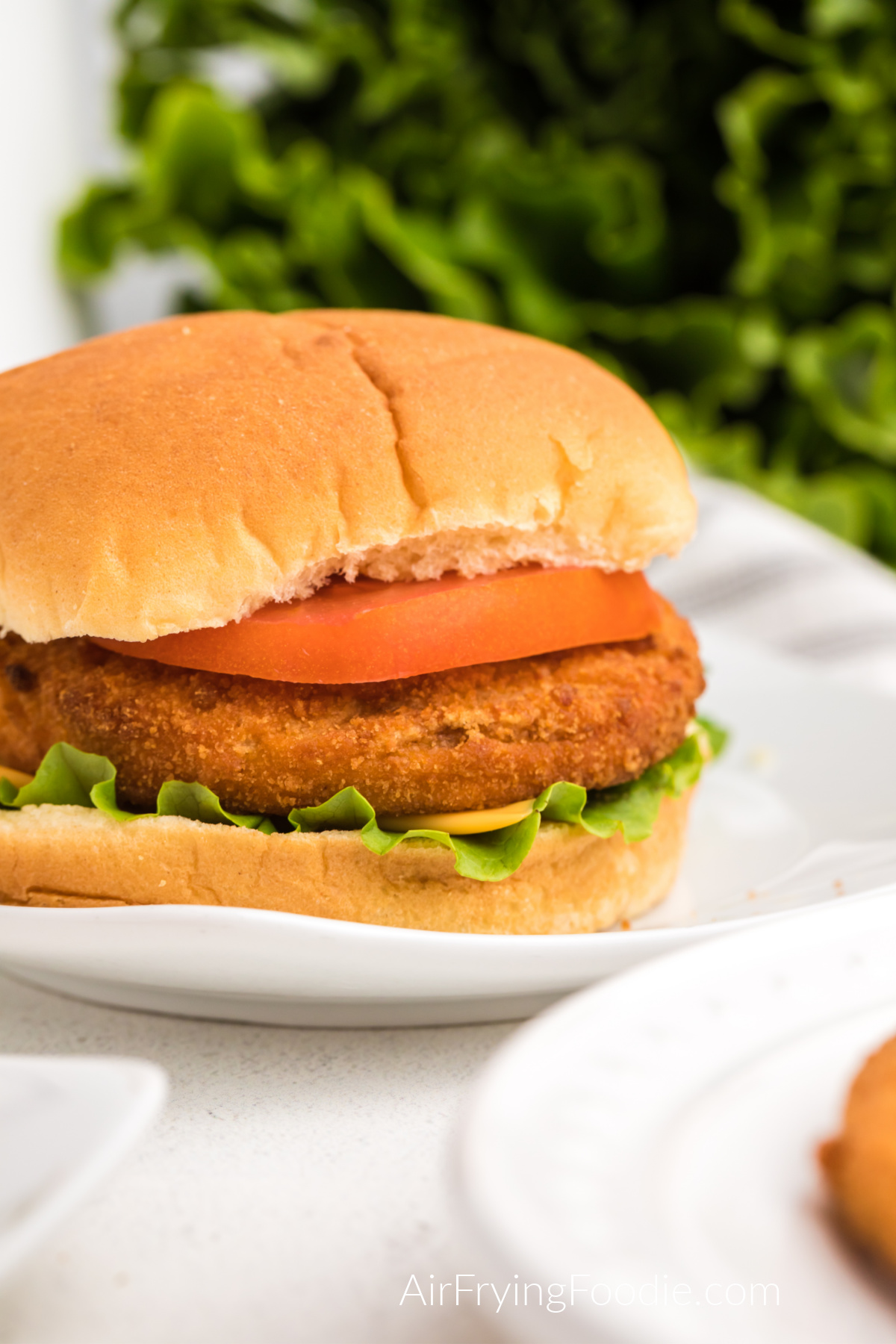 Tyson frozen chicken patties are fully cooked and on a bun, ready to serve.