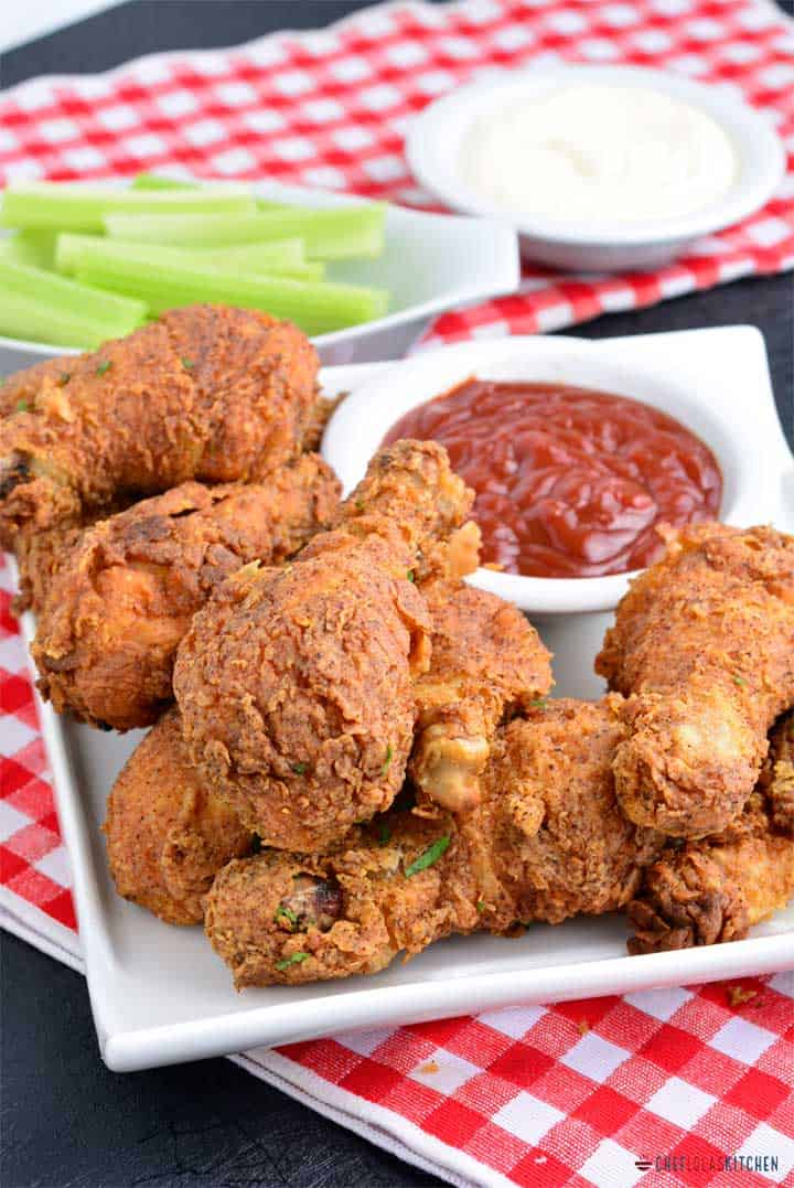 Crispy fried chicken thighs with ketchup and celery