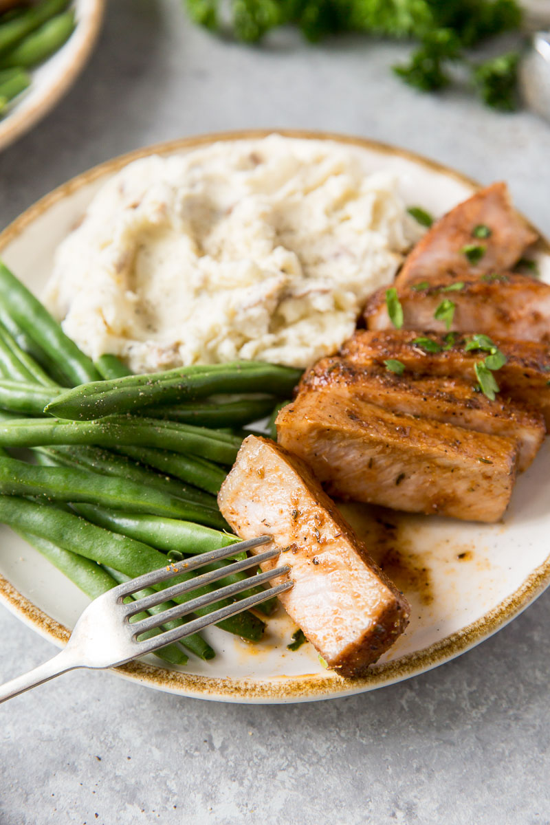 shovel thinly sliced ​​pork on plate with fork