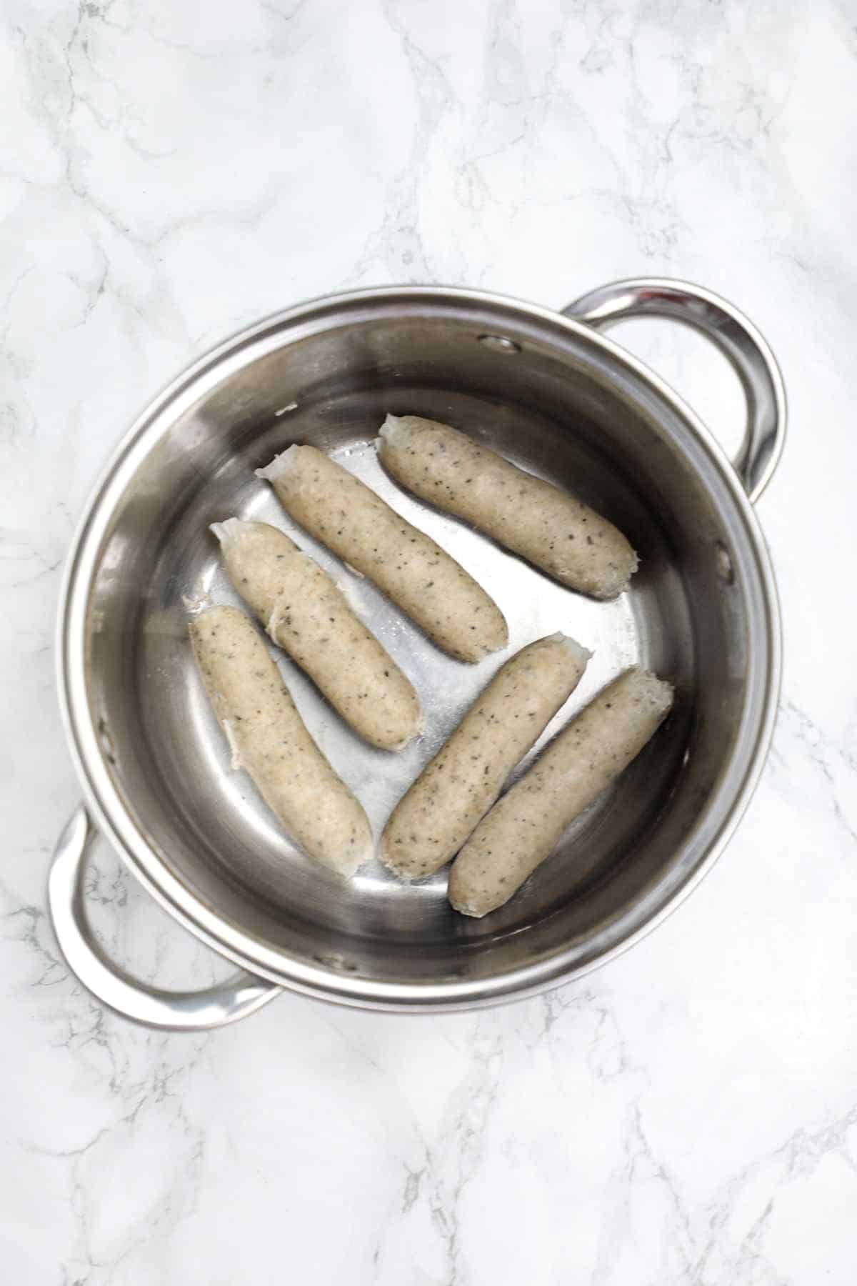 Cooked sausages in a pot.