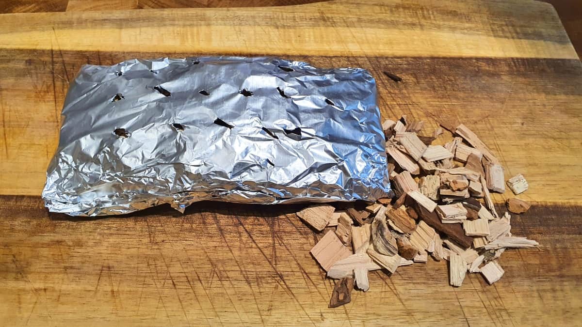 A pack of homemade foil to smoke wood chips in the oven