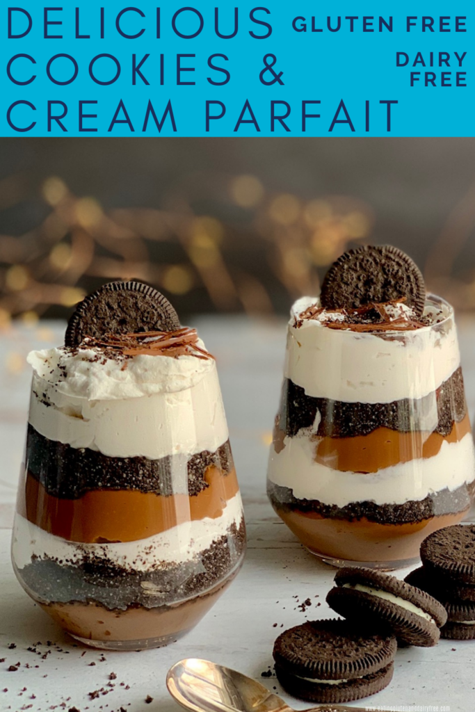 3 layered glass jars with homemade thick chocolate pudding, crushed oreo cookies, and a creamy white topping. Then, topped with crushed biscuits, an oreo-like cookie, and chocolate chips. Next to the glass jars are cookies more like Oreo.