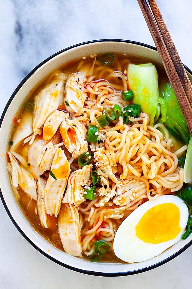 Spicy Instant Pot ramen noodles with ramen egg, bok choy, shredded chicken in chicken broth.