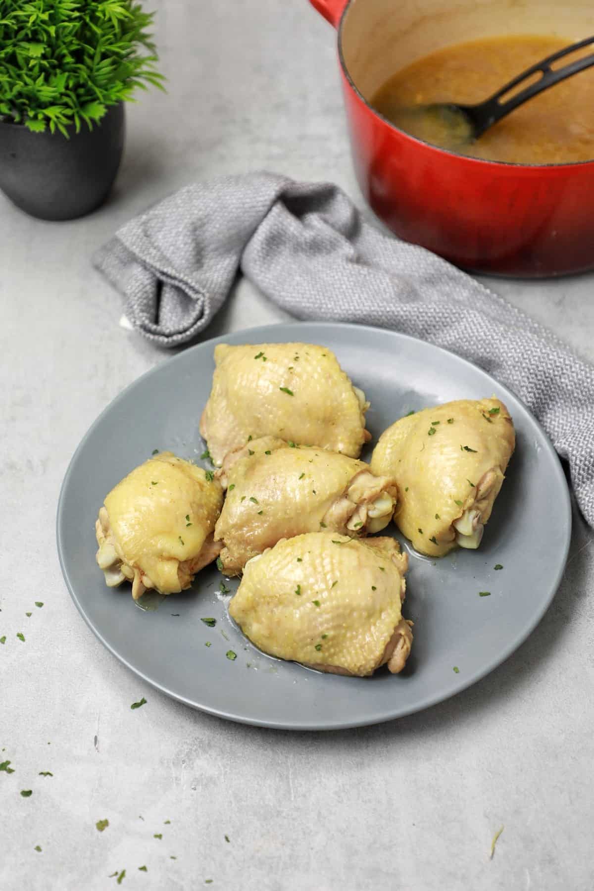 Serve plates and pots with broth in the background.