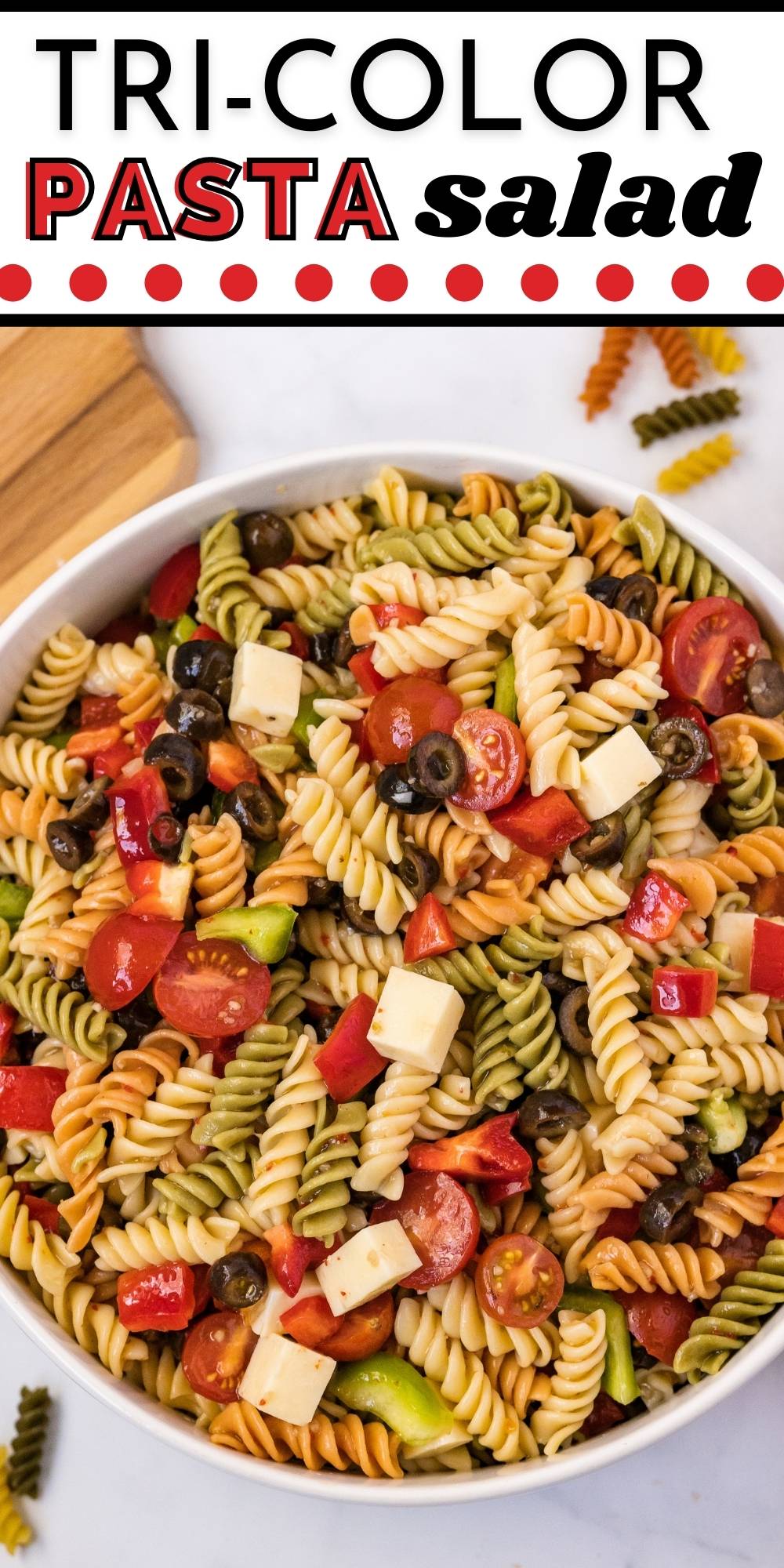This tricolor pasta salad with Italian dressing is made with rotini, Italian dressing, mozzarella cheese, bell peppers, black olives, and cherry tomatoes. via @foodfolksandfun