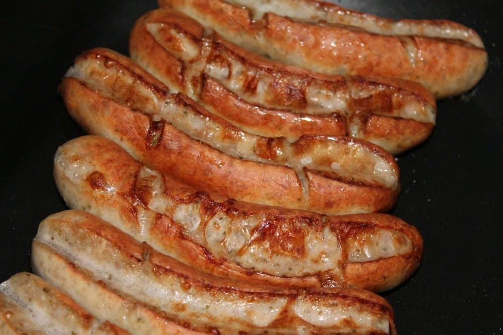intact casings on brats on a propane grill