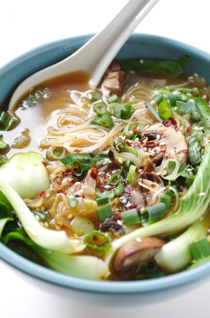 A bowl of nutritious garlic ginger noodle soup with bok choy and mushrooms