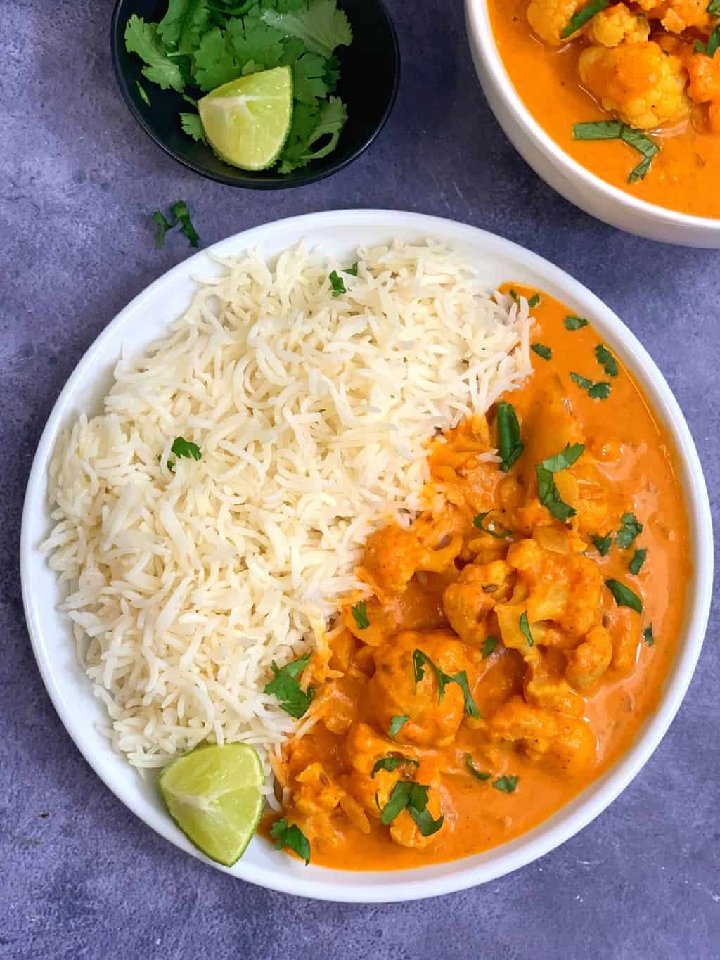 Serve the coconut cauliflower curry on a plate with basmati rice and passion fruit