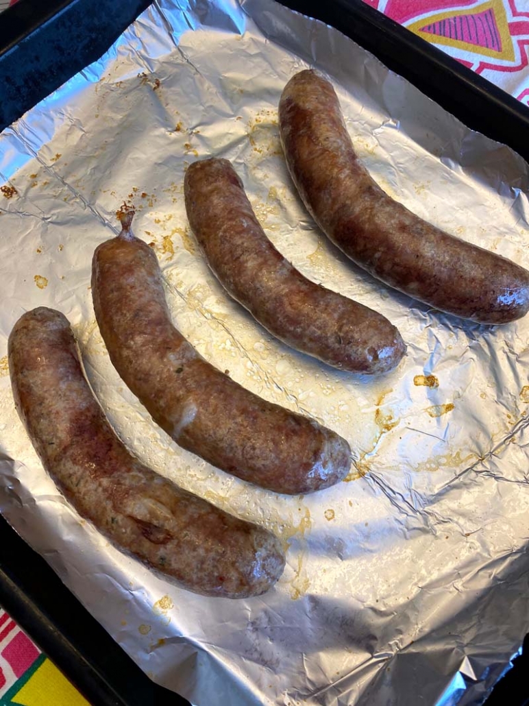 Grilled Italian sausage on a foil pan