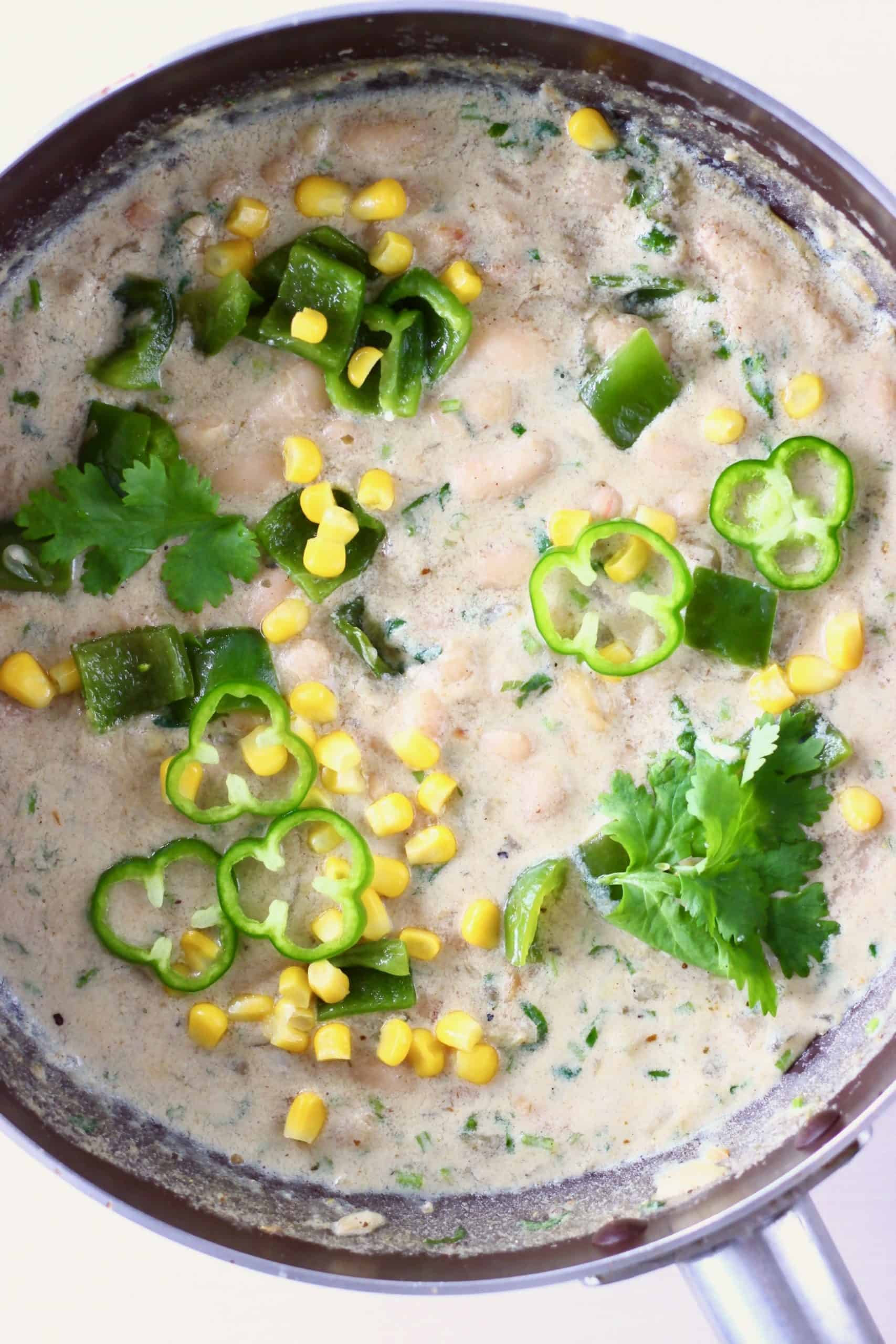 Chickpeas mango cashews coconut curry with rice on a brown plate