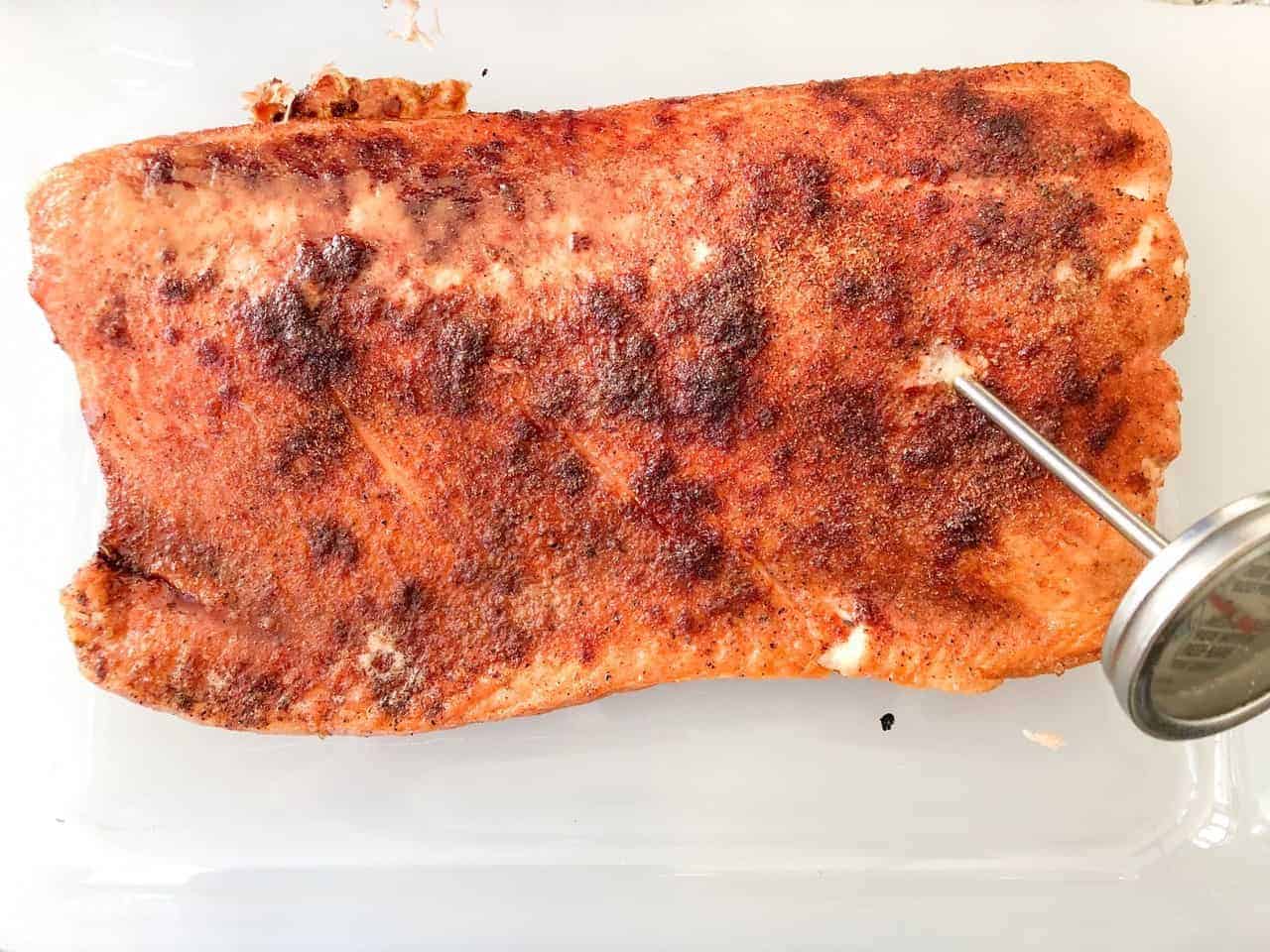 The salmon fillet has reached the temperature on the grill