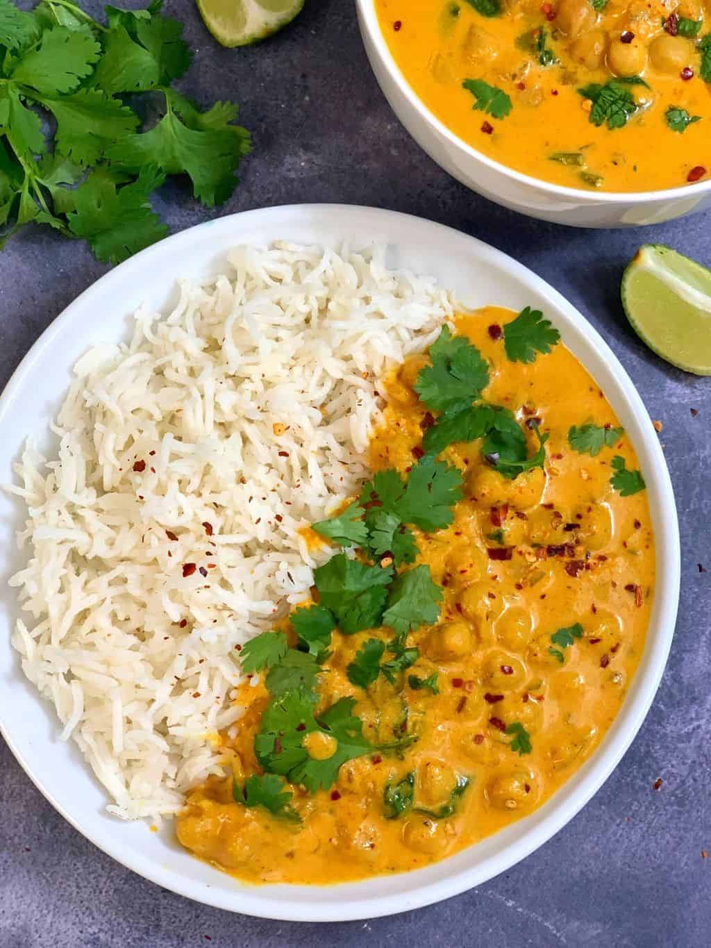 Vegetarian chickpea curry with basmati rice on a white plate