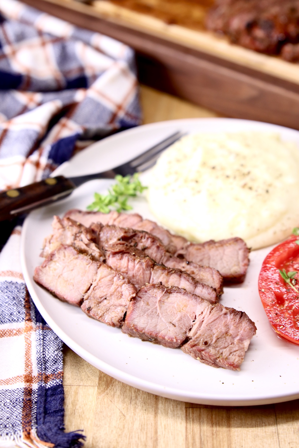 Grilled beef slices on a plate with mashed potatoes