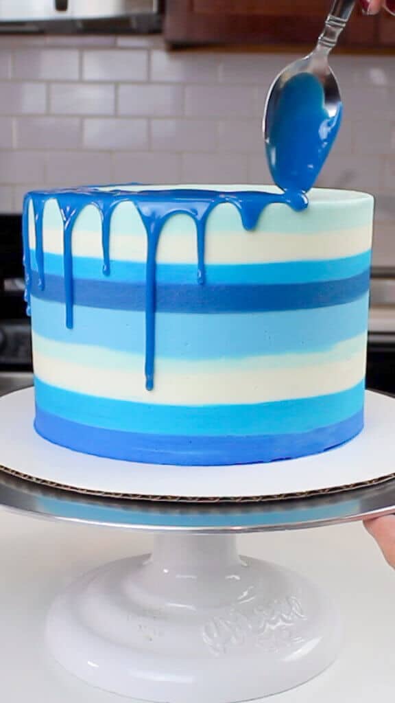 image of a blue drop of water added to a striped blue cake