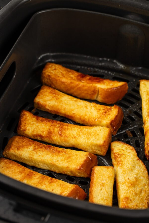 French toast toasted golden brown in an air fryer.