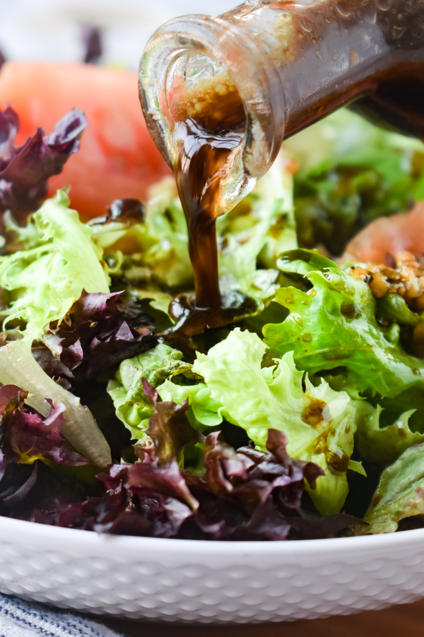 Balsamic Vinaigrette is poured over green salad