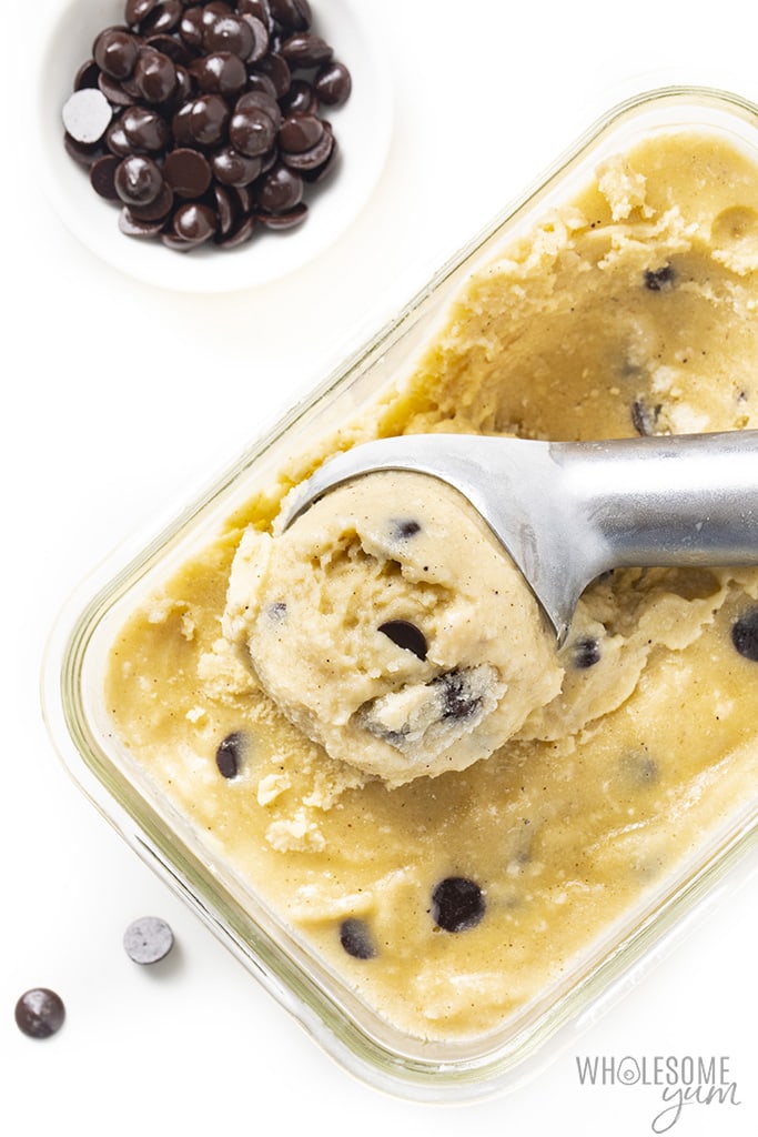 Homemade almond milk ice cream in a glass container with chocolate chips