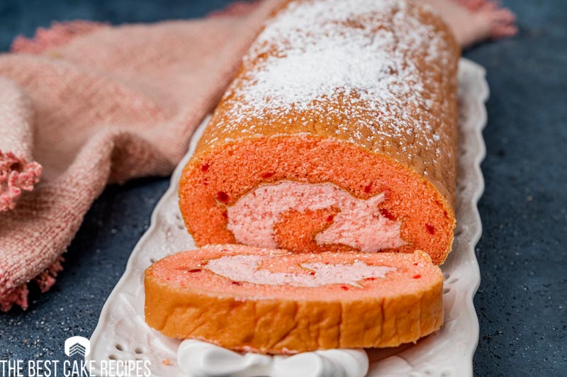 a cake roll on a plate with a slice