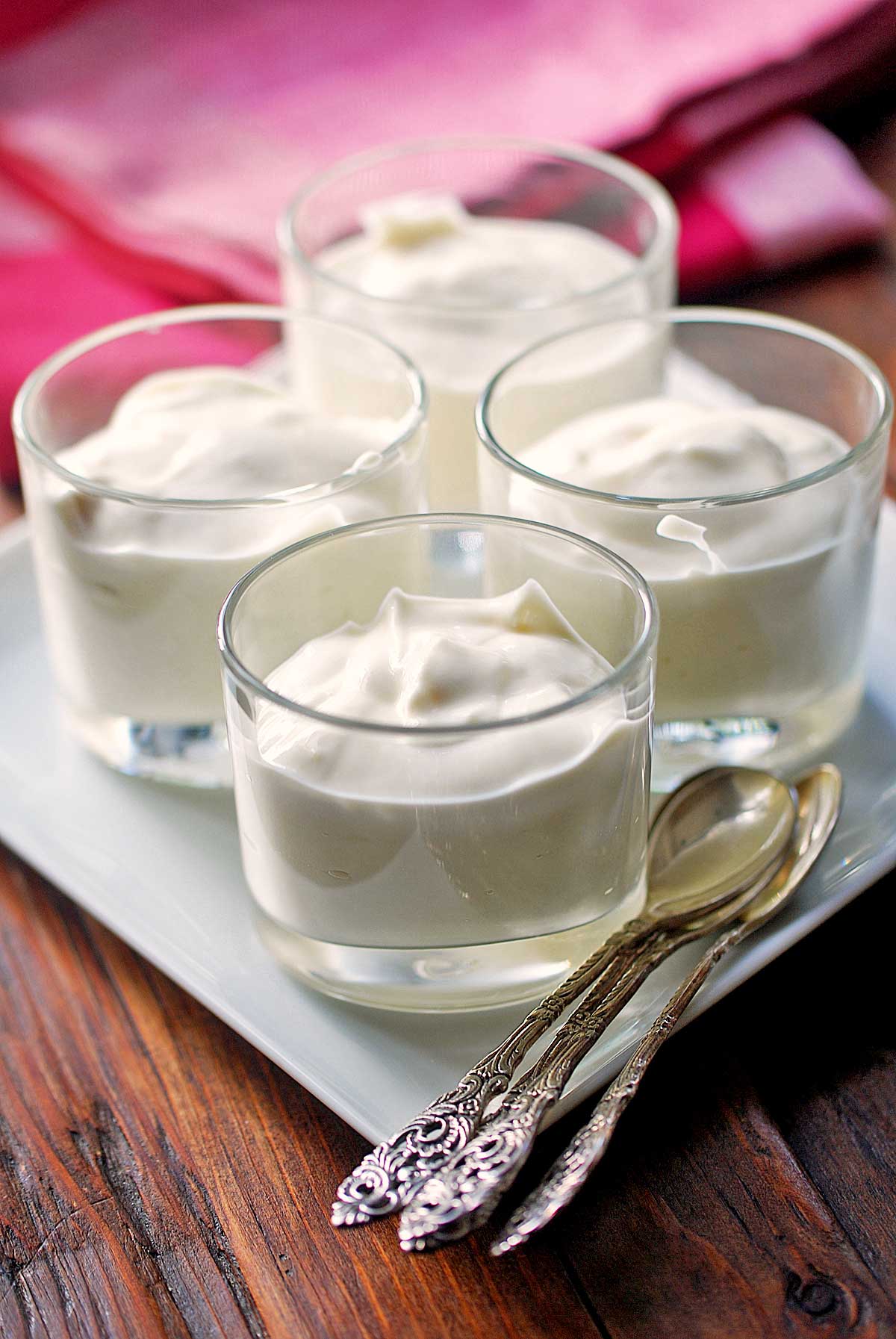 Ricotta desserts are served in small cups with spoons.