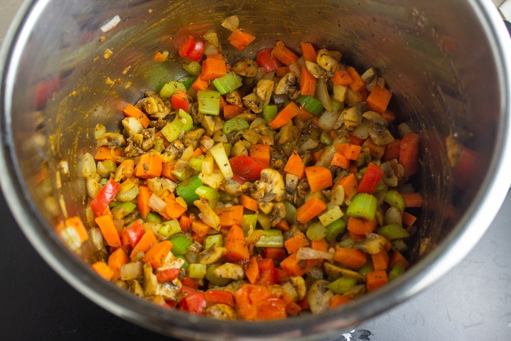 Stir-fry vegetables and raw rice in an instant pot