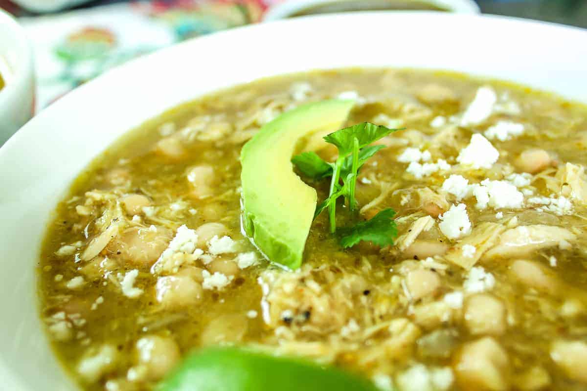 Close-up image of soup garnished with butter and cheese