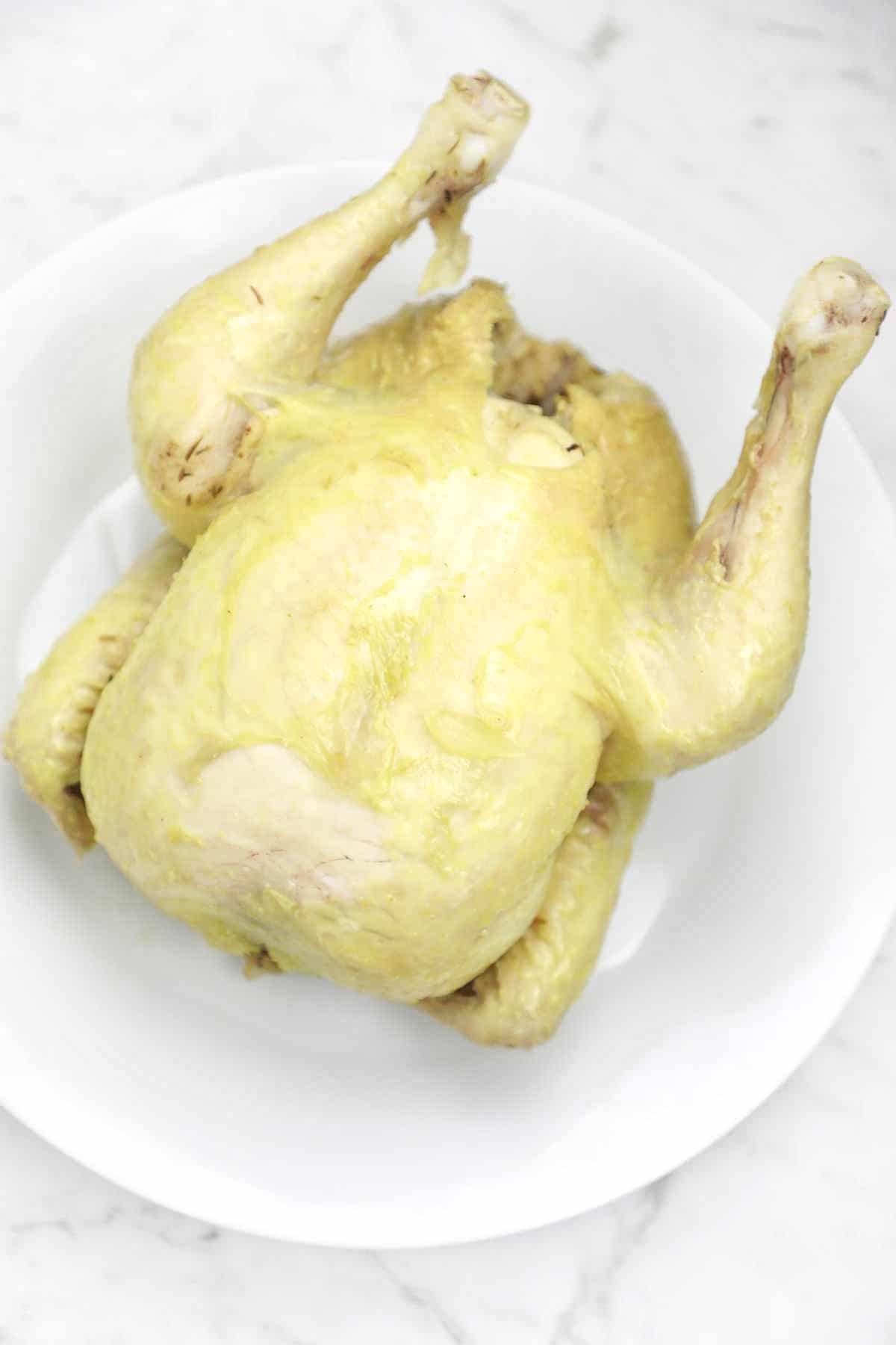 whole boiled chicken on a plate.