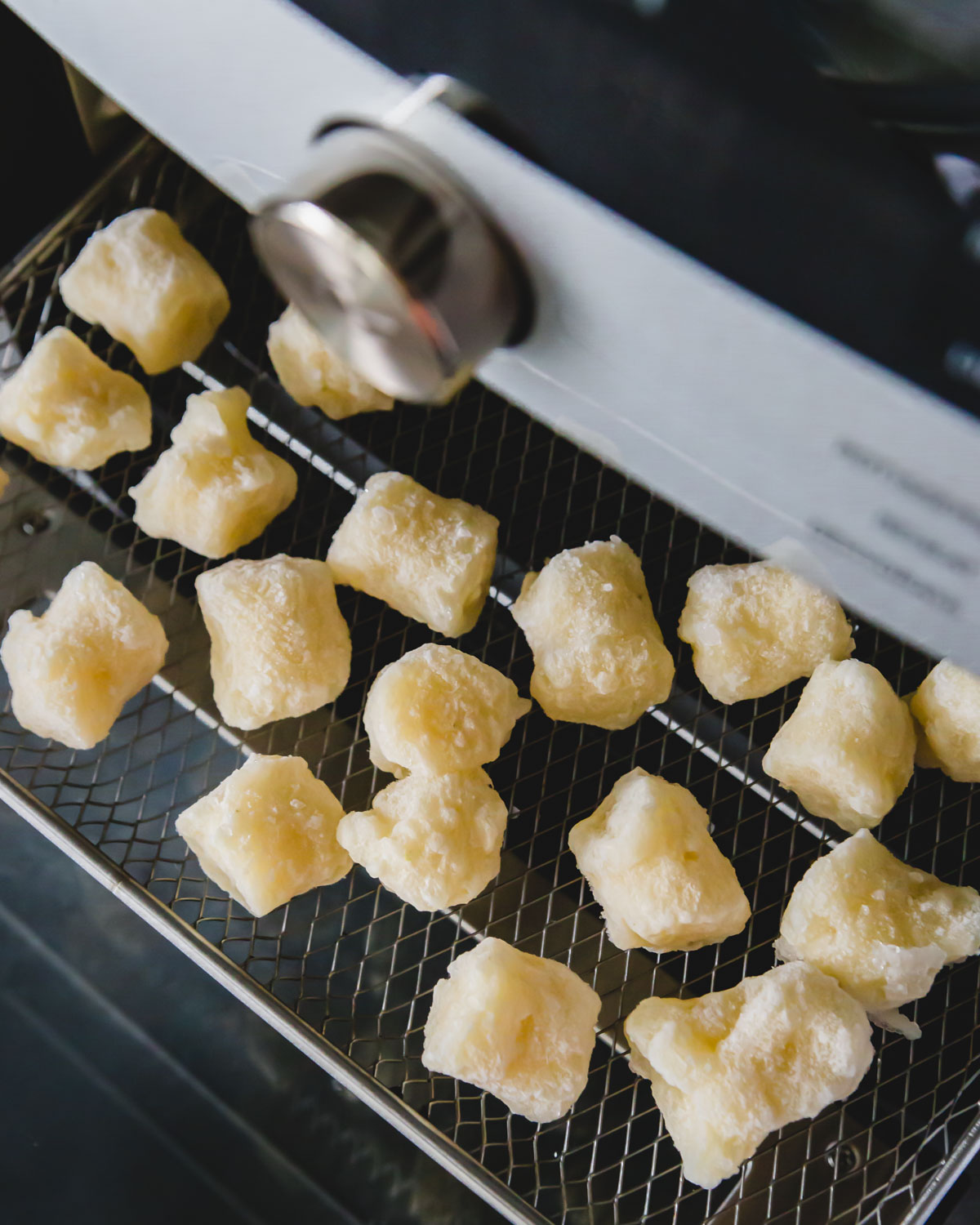 Frozen cauliflower gnocchi is cooked in an air fryer from the frozen state at 400 degrees for 18 minutes.
