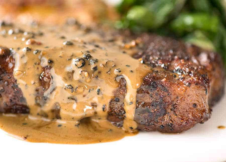 Close-up of the cream sauce with diarrhea running down the side of the steak