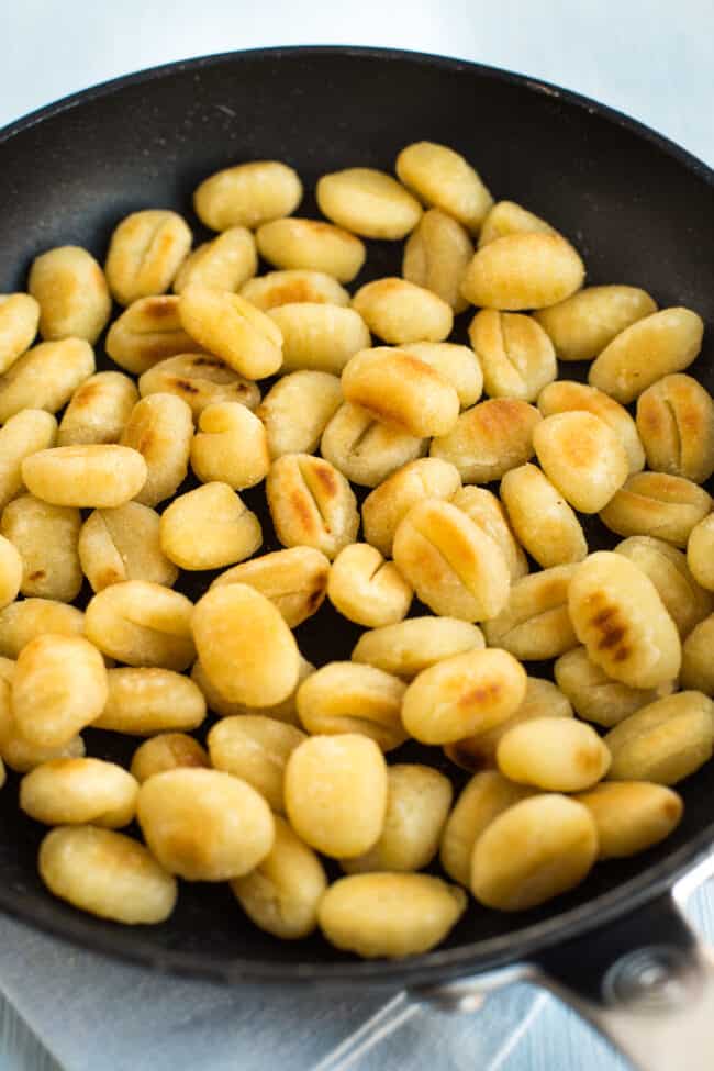 Gnocchi and vegetables in a creamy sauce with garlic bread.