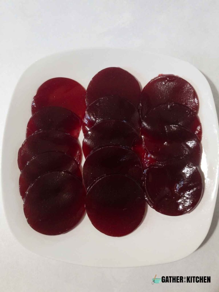 The cranberry jelly sauce is cut into balls and served on a plate.