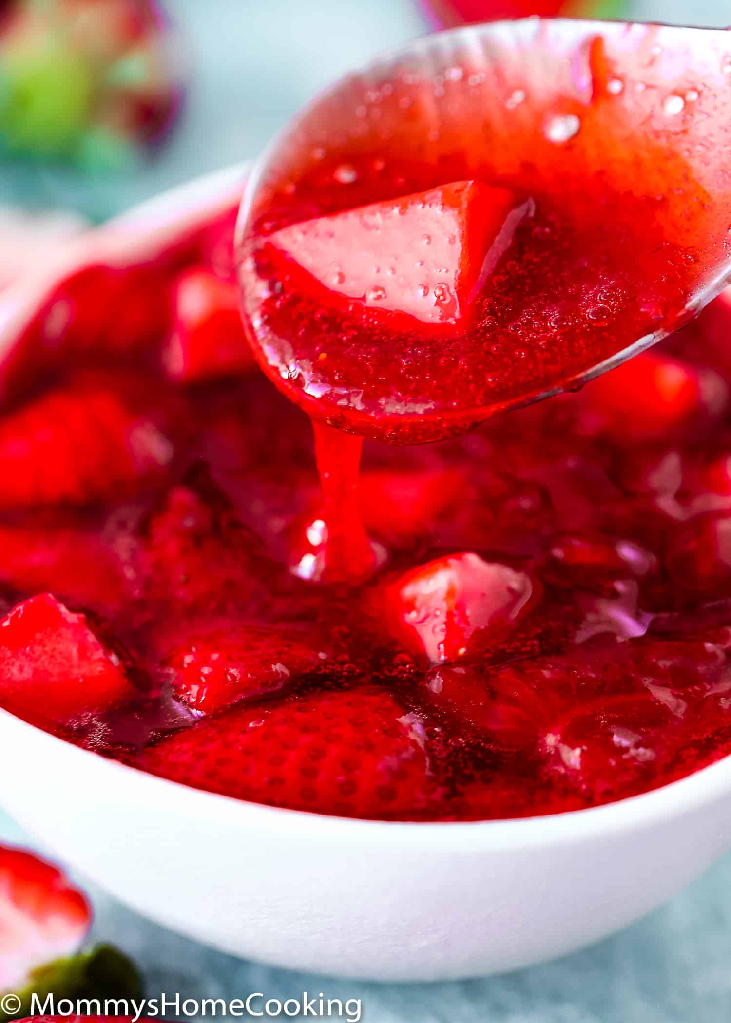 Close-up of strawberry sauce / topping in a spoon