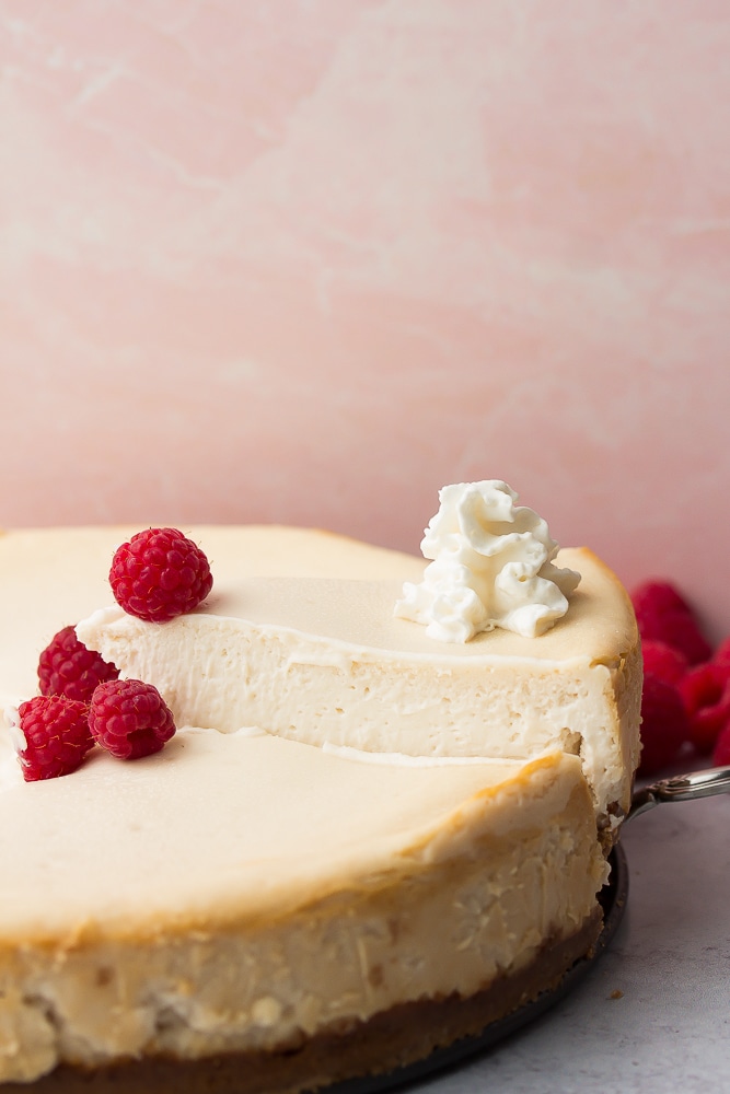 whole cheesecake with raspberries, sliced